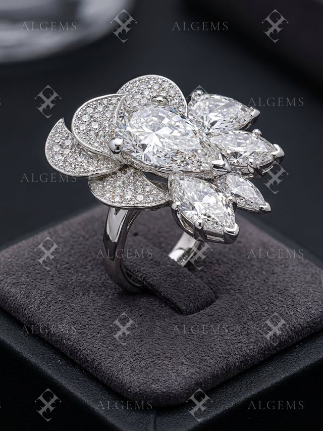 Diamond Petal Ring with an asymmetric pear and pavé floral head, held by its band in a slotted charcoal suede cushion